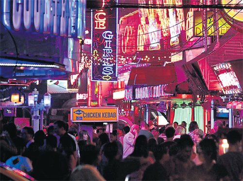 Colourful attraction: Tourists at Soi Cowboy in the Asoke area.